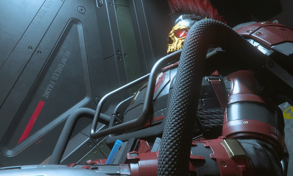 Close-up of crimson armor and golden mask inside a reinforced frame cockpit