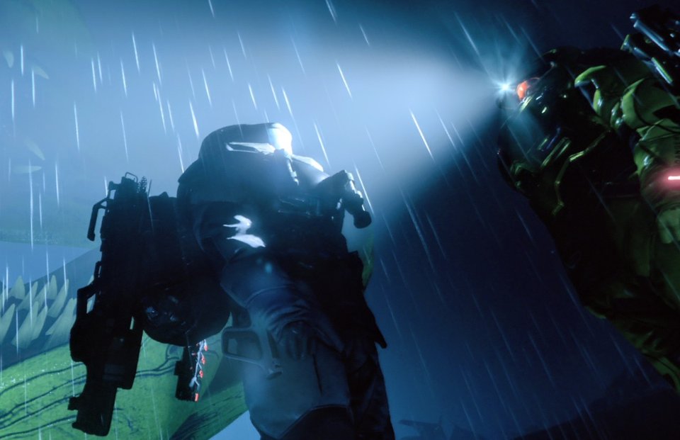 Explorer in heavy suit under rain with headlamp beam